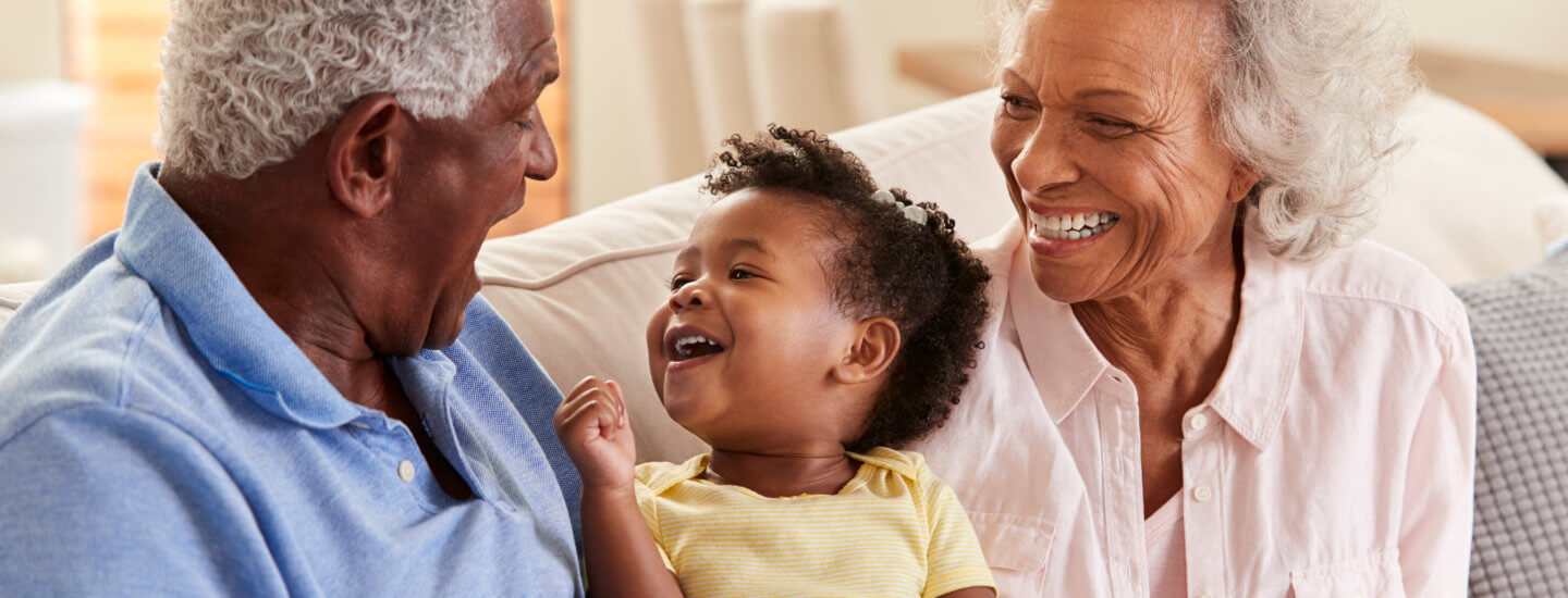 Grandparents and grandchild laughing