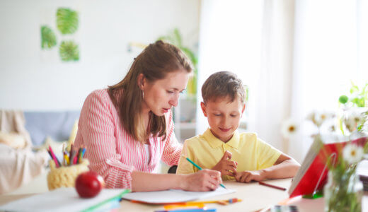 Mother assisting her son with homework