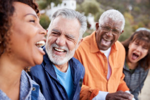 Older adult friends laughing outside