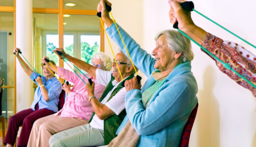 Group of seniors exercising while seated